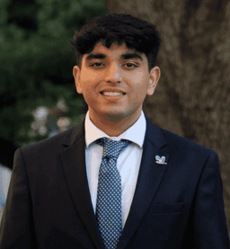 Ishaan in a suit on the TCU campus